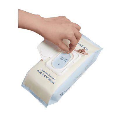 Hand reaching into a packet of Furbaby dog and cat wipes on a white background