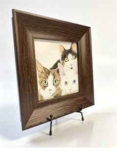 Dark wood memorial picture frame displaying a portrait of three cats on a black metal tabletop stand