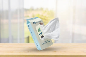 Pack of dog and cat wipes on a wooden surface with a blurred background