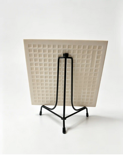 Rear angled view of a custom pet portrait tile supported by a black metal tabletop display easel