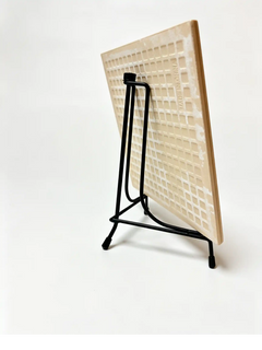 Rear angled view of a custom pet portrait tile supported by a black metal tabletop display easel