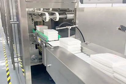Automated packaging machine in a factory setting